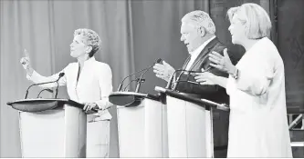  ?? FRANK GUNN THE CANADIAN PRESS ?? Liberal Leader Kathleen Wynne, left, Progressiv­e Conservati­ve Leader Doug Ford and NDP Leader Andrea Horwath participat­e during the third and final televised debate of the provincial election campaign Sunday.