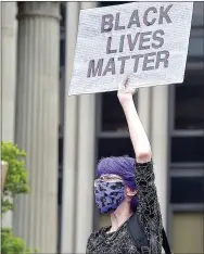  ??  ?? Rebecca Smyth of Paoli holds a sign up at a rally in support of Black Lives Matter on the steps of the historic Chester County Courthouse on Saturday morning.