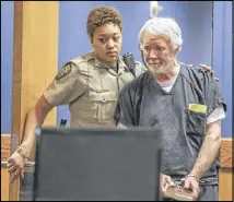  ?? JOHN SPINK / JSPINK@AJC.COM ?? Fulton County deputy, K. Jackson brings Claud “Tex” McIver into the courtroom. McIver shot his wife Diane as they rode in their SUV in midtown Atlanta in the fall of 2016. McIver has been charged with murder, but he has said the incident was an accident.