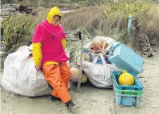  ??  ?? Trash heap . . . Boi Rickertsen, of Invercargi­ll, sits on bags of rubbish collected on the beaches of Stewart Island.