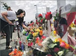  ?? Mario Tama Getty Images ?? IN EL PASO, a memorial honors victims of the Aug. 3 mass shooting at a Walmart. A shooting rampage in western Texas followed on Aug. 31.