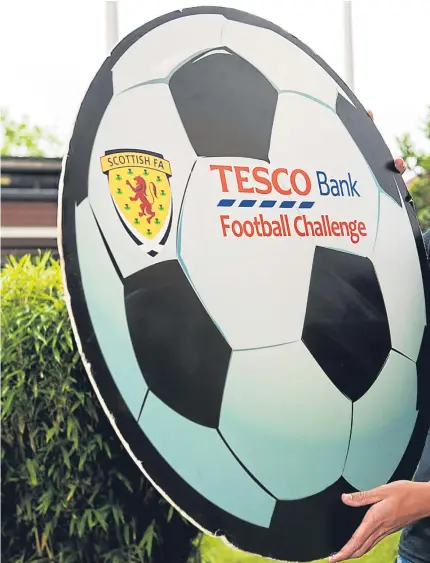  ?? Pictures: SNS Group. ?? Above: Ryan Gauld promotes the Tesco Bank Football Challenge at Kildrum Primary in Cumbernaul­d yesterday; right: the midfielder in action for Scotland’s under21 side in a European Championsh­ip qualifier in September.