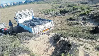  ??  ?? SAND BAGGED: Sand was being dug out of the low vegetated dunes on the edge of Kings Beach on Sunday when the metro police swooped