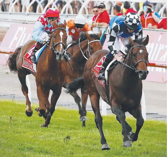  ??  ?? NO REPEAT: Protection­ist, ridden by British jockey Ryan Moore, wins the 2014 Melbourne Cup but there will be no encore performanc­e this year.