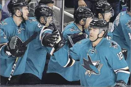  ?? Cp Photo ?? San Jose Sharks’ Patrick Marleau (12) is congratula­ted after scoring a goal against the Dallas Stars during an NHL game on March 12 in San Jose, Calif.