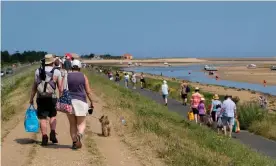  ?? Photograph: Matthew Chattle/Rex ?? People enjoy the summer weather at Wells-next-the-Sea on the north Norfolk coast.