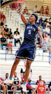  ?? [PHOTO BY BRYAN
TERRY, THE OKLAHOMAN] ?? Edmond North’s Marvin Johnson goes up for a dunk during the dunk contest at the boys Big All-City basketball game at Southmoore High School on Thursday.