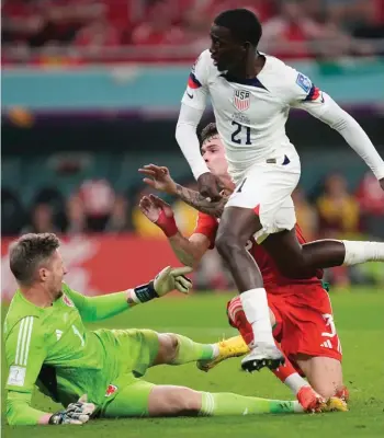  ?? ?? Tim Weah of the United States scores during the World Cup, group B soccer match between the United States and Wales