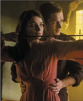  ?? Robin Hood ?? Eve Hewson and Taron Egerton as Maid Marian and Robin Hood in