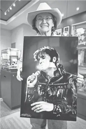  ?? THE COMMERCIAL APPEAL FILES ?? Jan. 7, 2021: Artist Betty Harper poses with a portrait she created of Elvis Presley in the gift shop of The Guest House at Graceland.