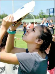  ?? Janelle Jessen/Herald-Leader ?? Eighth-grader Yoceline Gomez took a photo of the eclipse using eclipse glasses and her smartphone.