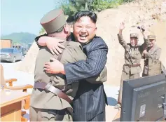  ?? — Reuters photo ?? Kim reacts with scientists and technician­s of the DPRK Academy of Defence Science after the test-launch of the interconti­nental ballistic missile Hwasong-14 in this undated photo released by North Korea’s Korean Central News Agency (KCNA) in Pyongyang.