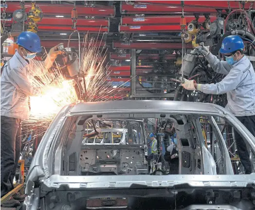  ??  ?? SPARKS FLY: A body shop at the Ford automotive plant in Hai Duong province. Vietnam boasts one of Southeast Asia’s fastest growing economies.