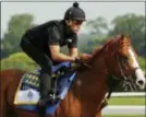  ?? JULIE JACOBSON — THE ASSOCIATED PRESS ?? Triple Crown hopeful Justify gallops around the main track during a workout at Belmont Park on Friday in Elmont, N.Y. Justify will attempt to become the 13th Triple Crown winner when he races in the 150th running of the Belmont Stakes on Saturday.