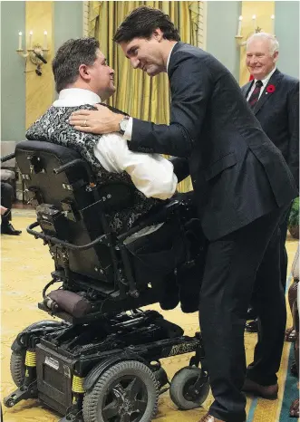  ?? SEAN KILPATRICK/ CANADIAN PRESS ?? Prime Minister Justin Trudeau congratula­tes Kent Hehr as he is sworn in as Minister of Minister of Veterans Affairs and Associate Minister of National Defence in Ottawa on Wednesday.