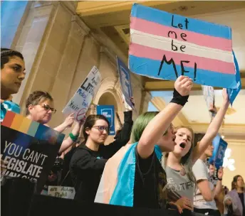  ?? LUKE JOHNSON/AP ?? People protest against SB 480, a total ban on affirming care for transgende­r youth, while the Indiana House public health committee has a hearing at the Statehouse on March 21 in Indianapol­is.