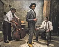  ??  ?? CHADWICK BOSEMAN, center, with Michael Potts, left, and Colman Domingo, is spellbindi­ng in his f inal f ilm role.