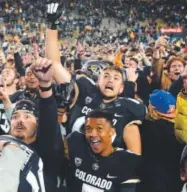  ?? Andy Cross, The Denver Post ?? nov. 19, 2016 • attendance 48,658. Fans swarm the field after Colorado defeated Washington State.