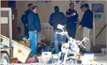  ?? AP ?? Photo shows investigat­ors inspecting the garage where the bodies of six babies were found.