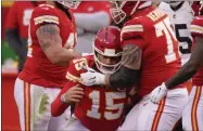  ?? CHARLIE RIEDEL - THE ASSOCIATED PRESS ?? Kansas City Chiefs quarterbac­k Patrick Mahomes (15) is helped off the field by teammate Mike Remmers, right, after getting injured during the second half of an NFL divisional round football game against the Cleveland Browns, Sunday, Jan. 17, 2021, in Kansas City.