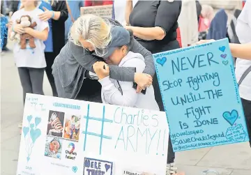  ??  ?? Supporters of Charlie react outside the High Court after the mother abandoned her fight to seek further treatment. — Reuters photo