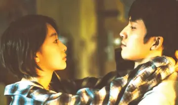  ??  ?? Zhou Dongyu (left) and Jing Boran in a scene from ‘Us and Them’.