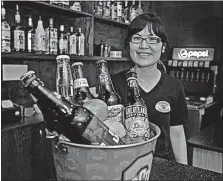  ?? [TOM DODGE/DISPATCH] ?? Wendy Wang shows bottled beers.