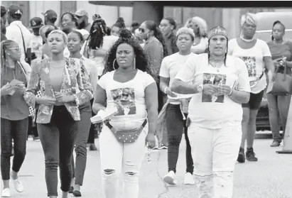  ?? AMY DAVIS/BALTIMORE SUN ?? Mourners for Tracey Carrington, some wearing T-shirts with her picture, leave Tuesday’s funeral service.