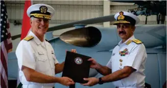  ?? (photo: MC2(SW/AW) Sara Eshleman) ?? Vice Adm. Kenneth Whitesell, Commander, US Naval Air Forces, left, presents the Material Inspection and Receiving Report for first aircraft to Vice Adm. Ravneet Singh, Indian Navy Deputy Chief of Naval Staff, during an acceptance ceremony at Naval Air Station North.