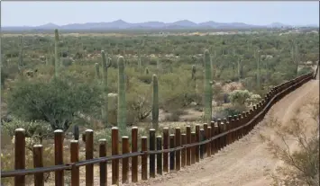  ?? PHOTO/MATT YORK AP ?? This Feb. 17, 2006, file photo,shows the internatio­nal border line made up of bollards: irregular, concrete-filled steel poles, seperating Mexico, left from the United States, in the Organ Pipe National Monument near Lukeville, Ariz.