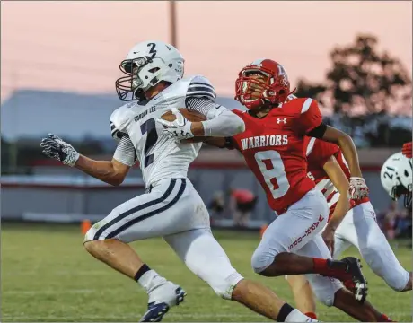  ??  ?? Gordon Lee's Braden Jarvis tries to sprint past LFO's Ruddy Ware during Friday's game in Fort Oglethorpe. The Trojans won 51-24 to move to 3-0 on the season. (Photo by Greg Collins/collinspic­tures.com) Gordon Lee 5, Central-Carroll 3