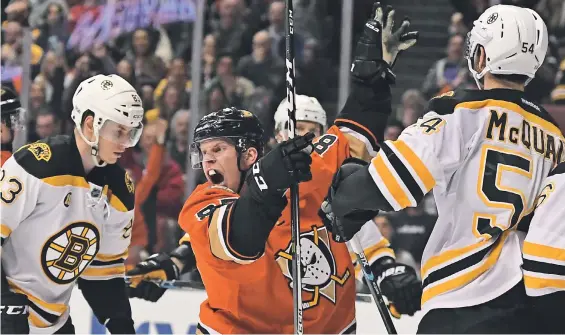  ?? AP PhOTO ?? ROAD BUMP: The Bruins' Peter Cehlarik (left) and Adam McQuaid can only watch as the Ducks' Ondrej Kase celebrates a goal last night. The B's fell, 5-3.