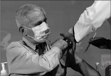  ?? PATRICK SEMANSKY / ASSOCIATED PRESS (2020) ?? Dr. Anthony Fauci, then director of the National Institute of Allergy and Infectious Diseases, prepares to receive his first dose of the COVID-19 vaccine Dec. 22, 2020, at the National Institutes of Health in Bethesda, Md.