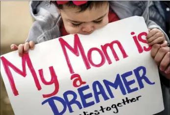  ??  ?? Yesenia Aguilar of Reading, Penn. holds her one year old daughter Denalli Urdaneta at an immigratio­n rally on Capitol Hill in Washington on Tuesday. President Donald Trump proposed a plan in which includes a citizenshi­p path to nearly 2 million...