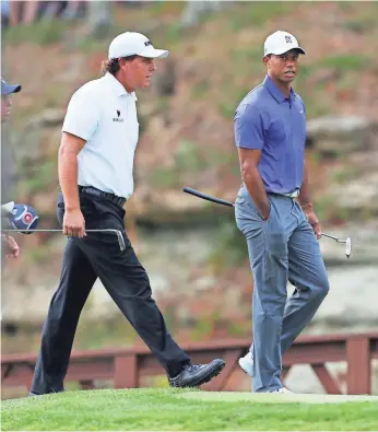  ?? BRIAN SPURLOCK, USA TODAY SPORTS ?? Phil Mickelson, left, and Tiger Woods were paired in the first two rounds of the 2014 PGA Championsh­ip. Woods missed the cut, but Mickelson finished as runner-up to Rory McIlroy.