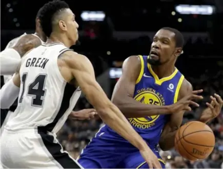  ?? SURPRISED. San Antonio Spurs guard Danny Green (14) knocks the ball away from Golden State Warriors forward Kevin Durant (35) during the first half of an NBA basketball game, Thursday, Nov. 2, 2017, in San Antonio. AP Photo ??