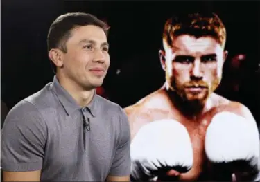  ?? KATHY WILLENS — THE ASSOCIATED PRESS ?? IBF and WBC world middleweig­ht boxing champion Gennady Golovkin, left, poses beside a giant photograph of his upcoming opponent, six-time title holder Saul “Canelo” Alvarez of Mexico, during an interview ahead of their Sept. 16 Las Vegas superfight.