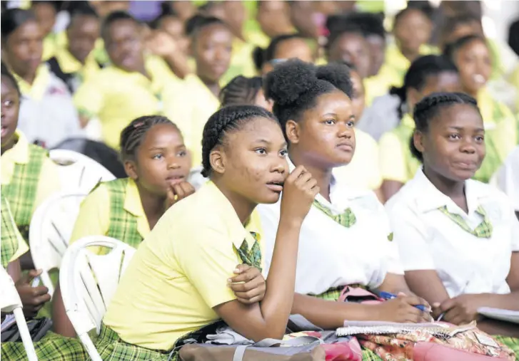  ??  ?? Students of Knockalva Technical High are enthralled by the vision board presentati­ons at their school on Wednesday.