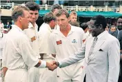  ??  ?? And what do you do? Robert Mugabe, no cricket lover, greets Alec Stewart (left) and Michael Atherton on England’s tour of Zimbabwe in 1996