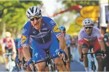  ?? CHRISTOPHE ENA/ASSOCIATED PRESS ?? Italy’s Elia Viviani celebrates as he crosses the finish line to win the fourth stage of the Tour de France on Tuesday in Nancy, France.