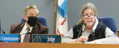  ?? ?? Judge Carol Sparks Drake talks with Dan Le Vay, attorney for the OUCC, as Commission­er David Ziegner, left, listens during a public forum Tuesday in East Chicago.