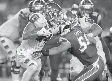  ?? Brian Blanco Getty Images ?? SOUTH FLORIDA linebacker Nico Sawtelle stops Temple running back David Hood in the second quarter.