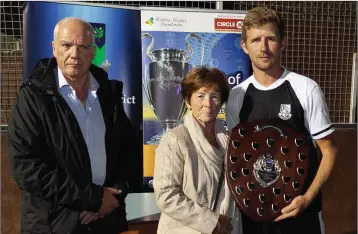  ??  ?? Michael Conlon, Chairman of the Wicklow League, with Margaret Heffernan presenting the Tommy Heffernan Shield to Newtown captain Neilly Martin.