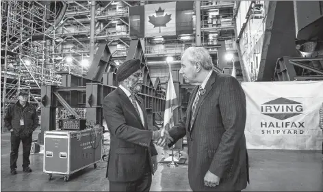  ?? CP PHOTO ?? Minister of National Defence Harjit Sajjan, left, shakes hands with Jim Irving, co-CEO of Irving Shipbuildi­ng Inc., following the announceme­nt that the Royal Canadian Navy will receive a sixth Arctic and offshore patrol ship at the Irving shipyards in Halifax on Friday.