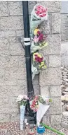  ??  ?? Bouquets placed at the Main Street site of the crash in Bridgend that killed Margaret Lowden.