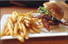  ?? Arkansas Democrat-Gazette/PHILIP MARTIN ?? Copper Grill’s Signature Sweet Hot Burger comes with thick “millionair­e’s bacon,” bacon jam, pimento cheese, arugula and sriracha.