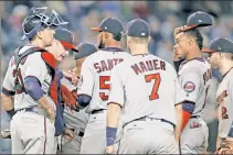  ?? AP ?? MOUND MEETING: The Twins huddle around starter Ervin Santana as he is removed from their 2-1 loss to the Yankees on Monday night in The Bronx.