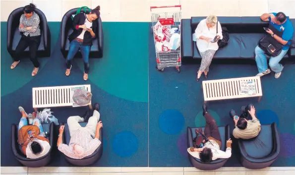  ?? Picture: Reuters ?? Shoppers take a break in between shopping inside a shopping mall in Sydney, Australia – with most of them spending their downtown on their cellphones. PLEASE CALL ME