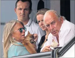  ??  ?? Sir Philip and Lady Green, left, and BHS staff, far right, hug as their store in Newport, South Wales closes down