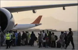  ?? BERNAT ARMANGUE — THE ASSOCIATED PRESS ?? Foreigners board a Qatar Airways aircraft at the airport in Kabul, Afghanista­n, Thursday.